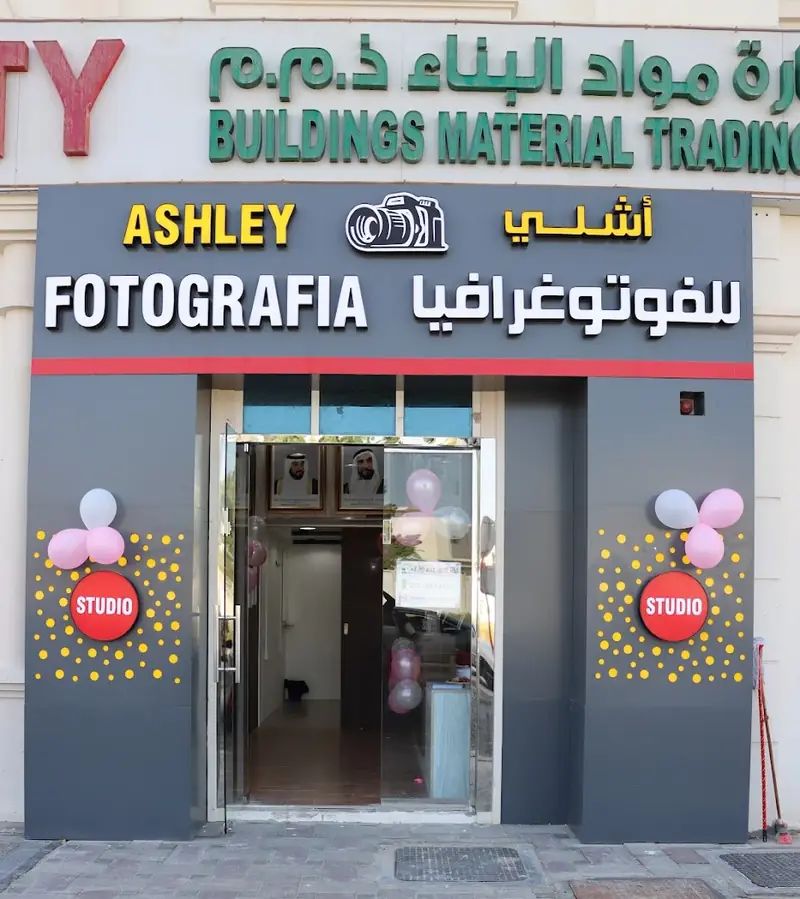 Ashley Fotografia shopfront in SE26, Khalifa City, with its sign in English and Arabic